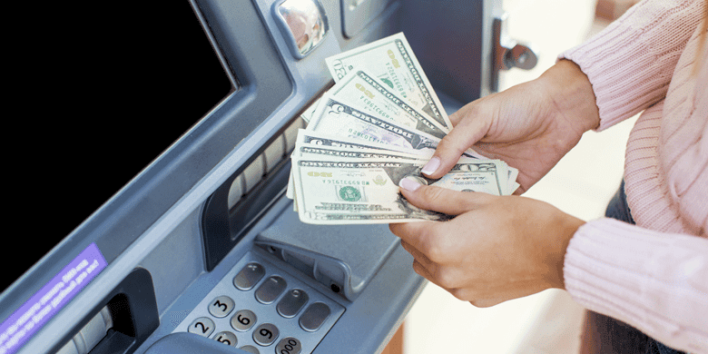 Person using ATM with credit card cash advance