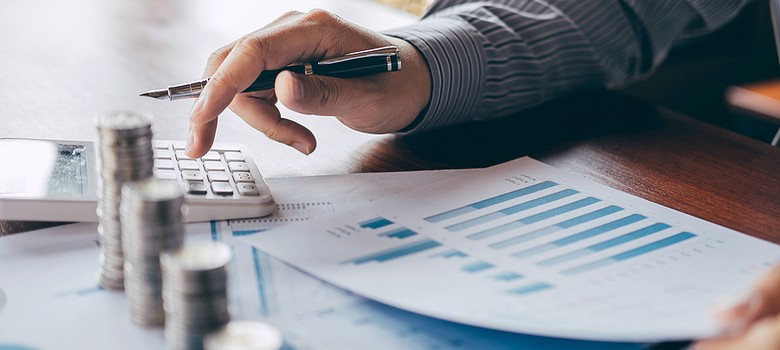 Man looking at chart and calculating debt